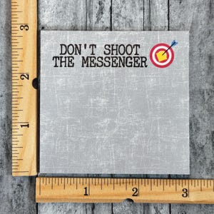May include: A gray note pad with the text "Don't Shoot The Messenger" and a red target with a yellow center and a blue arrow.