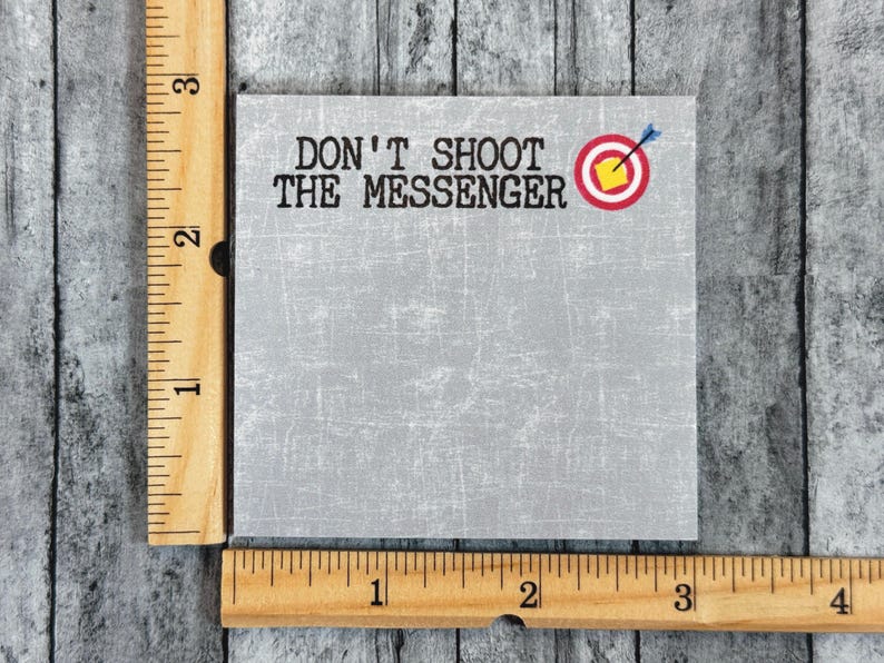 May include: A gray note pad with the text "Don't Shoot The Messenger" and a red target with a yellow center and a blue arrow.