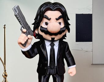 May include: A figurine of a character in a black suit, black tie, and black hair, holding a silver handgun. The character has a large mustache and a large nose. The figurine is standing on a wooden surface.