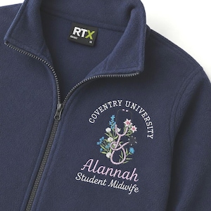 May include: A navy blue fleece zip-up jacket featuring an embroidered design of a stethoscope intertwined with colourful flowers. The text reads Coventry University, Alannah, and Student Midwife. The interior label displays the brand name RTX.