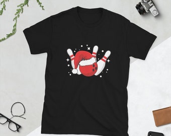 May include: Black t-shirt featuring a white bowling pin and red bowling ball wearing a Santa hat. The bowling pins are arranged in a triangular shape.