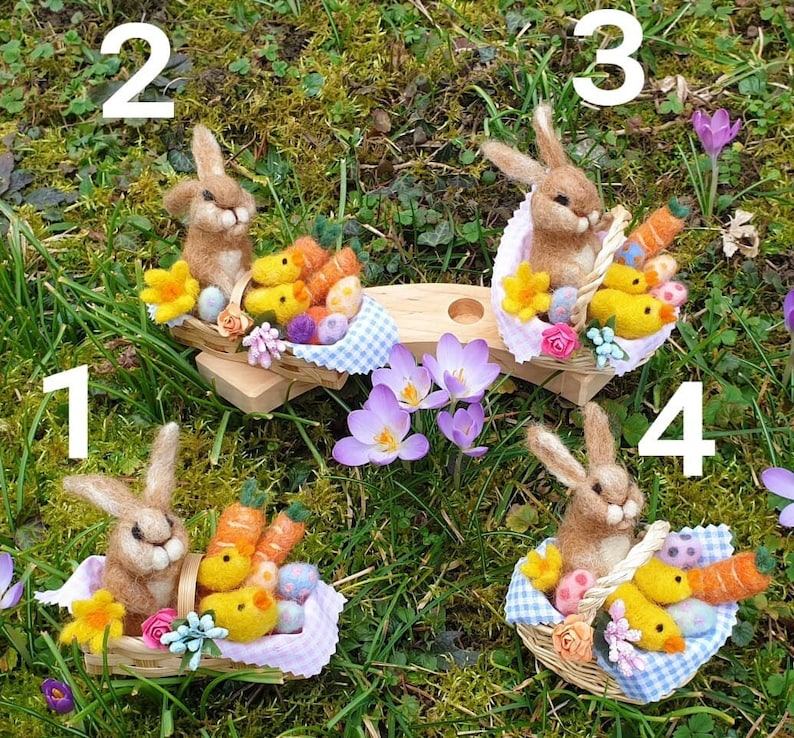 May include: Four felt Easter bunnies, each holding a basket filled with colorful eggs and chicks. The bunnies are sitting on a wooden platform with a blue and white checkered tablecloth. The background is a green grassy area with purple flowers.