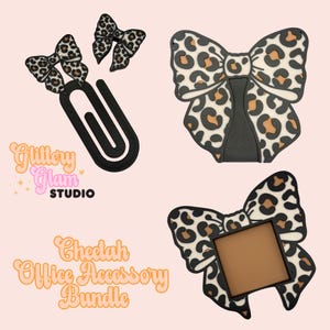 May include: Cheetah print office accessory bundle. Includes a large black paperclip with two small cheetah print bows, a large cheetah print bow, and a cheetah print bow with a brown square. The text "Glittery Glam Studio" and "Cheetah Office Accessory Bundle" are also visible.