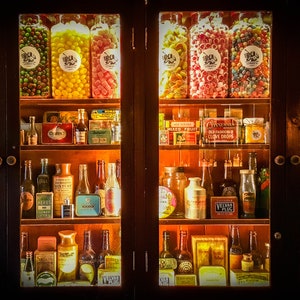 Photo print of antique shop display cabinet with old sweet jars, tobacco, alcohol, medicine, remedies packaging, wall art, home decor prints