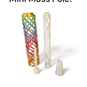 May include: The image displays several mini moss poles, including a colorful rainbow-hued pole, a white pole, a stake, and a cone-shaped base. The text "Mini Moss Pole!" is at the top. These are likely used for supporting plants.