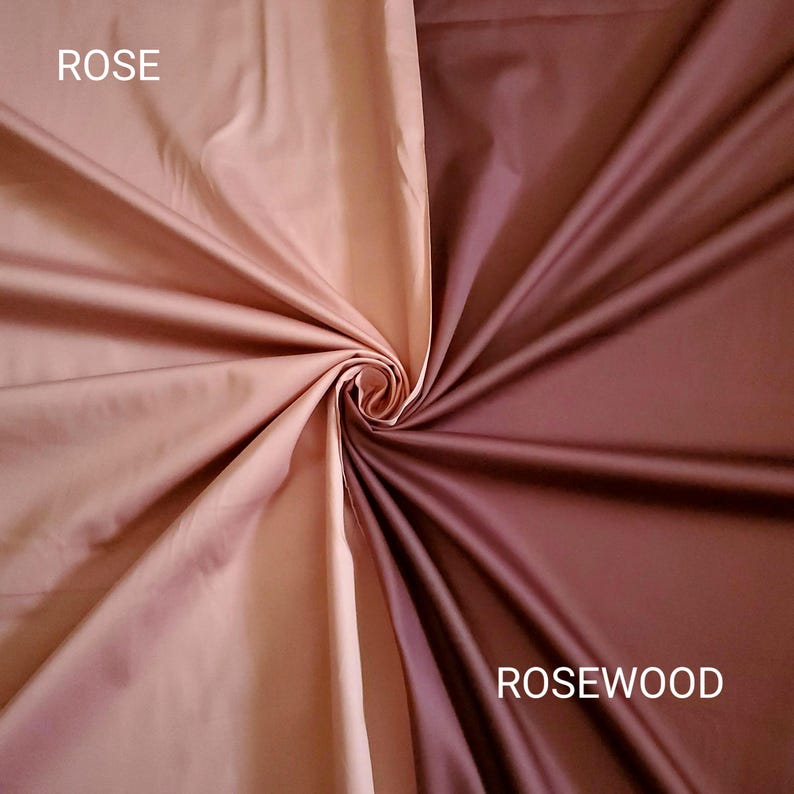 May include: A close-up of two fabric swatches, one in a rose colour and the other in a rosewood colour. The fabric is smooth and shiny, with the word "ROSE" in white text on the left and "ROSEWOOD" on the right.