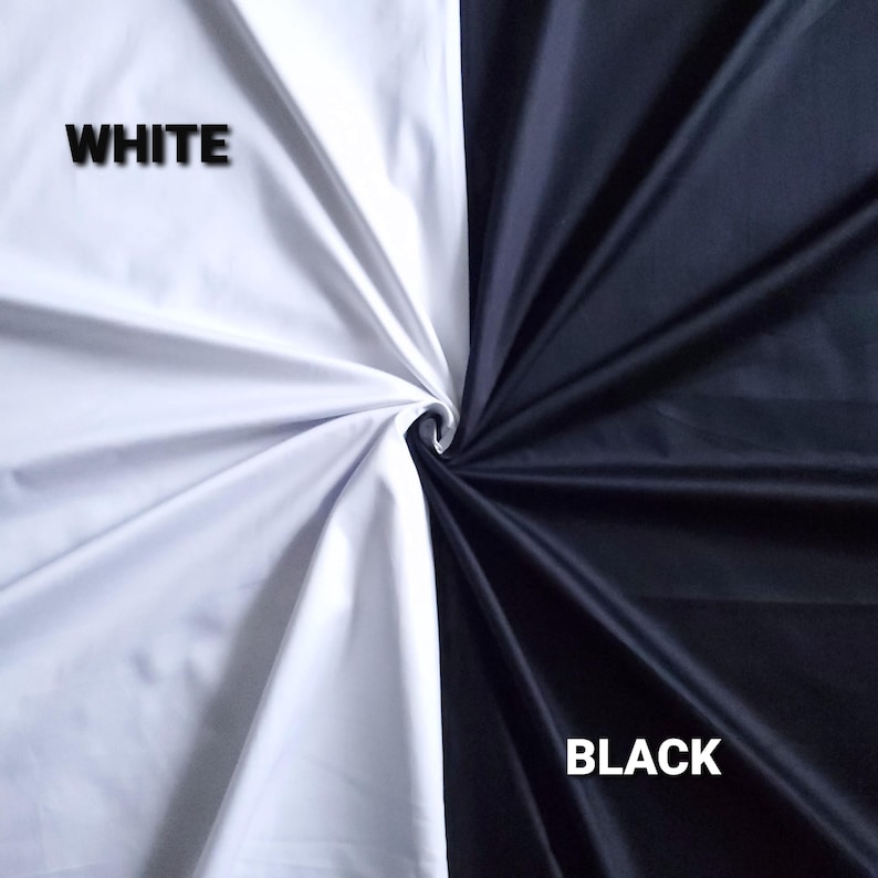 May include: A divided image displaying two fabric samples. One section is pure white, the other is jet black. The words "WHITE" and "BLACK" are printed on each side. The fabric is twisted at the centre.
