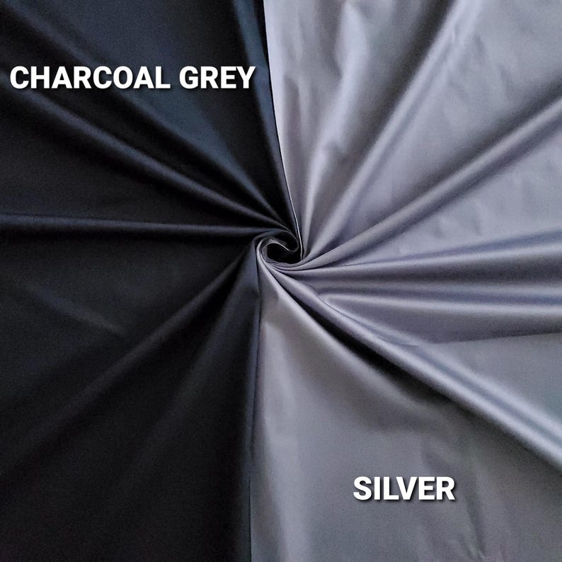 May include: A fabric sample divided diagonally, with charcoal grey on one side and silver on the other. The words "CHARCOAL GREY" and "SILVER" are printed in white, indicating the fabric colours.