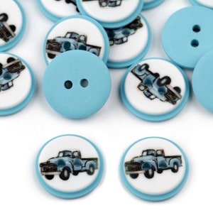 May include: A collection of blue and white plastic buttons with a vintage truck design. The buttons have two holes and are perfect for sewing projects.
