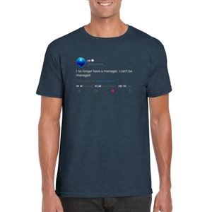 May include: A dark blue t-shirt featuring a white print of a tweet from Kanye West's Twitter account. The tweet reads "I no longer have a manager. I can't be managed." The tweet has 49.1K retweets, 22.6K likes, and 222.7K views.