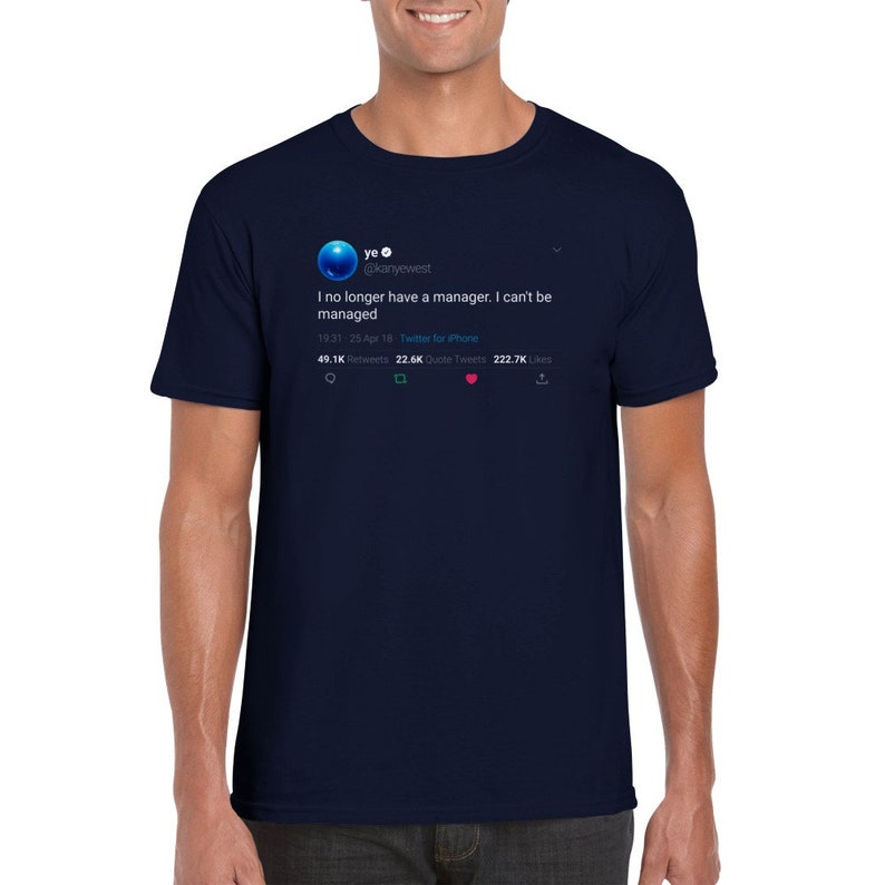 May include: A navy blue t-shirt featuring a white graphic of a tweet from Kanye West's Twitter account. The tweet reads "I no longer have a manager. I can't be managed." The tweet has 49.1K retweets, 22.6K quote tweets, and 222.7K likes.
