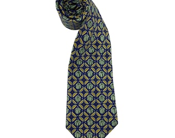 May include: A navy blue necktie featuring a repeating geometric pattern of light green circular shapes and yellow crescent accents. The tie is rolled at the top and tapers down to a pointed end, displaying a consistent print throughout the fabric.