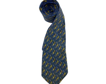 May include: A rolled-up blue tie with a repeating pattern of yellow and brown figures. The tie is made of a smooth fabric and is suitable for formal occasions. The tie is a classic accessory.