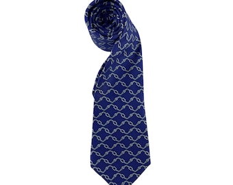 May include: A rolled-up blue necktie with a repeating chain pattern in a lighter blue color. The tie is made of a smooth fabric and is displayed against a white background. The tie is a classic accessory for formal or business attire.