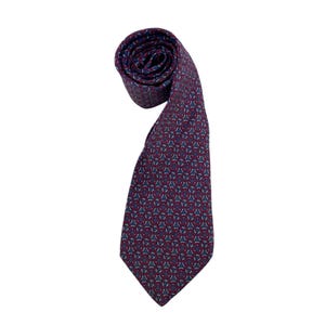 May include: Rolled burgundy tie with a repeating geometric pattern in blue and teal. The tie is made of a smooth fabric and is suitable for formal or business attire.