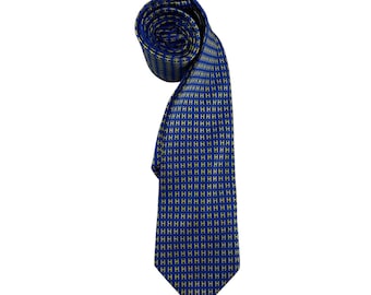May include: A rolled blue tie with a repeating yellow 'H' pattern. The tie is made of a smooth fabric and is displayed against a white background. The tie is a classic accessory for formal or business attire.