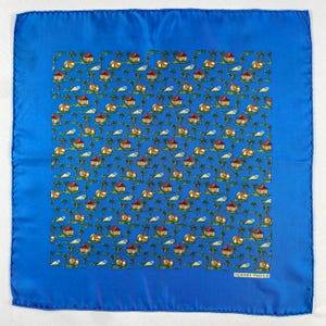May include: A square, blue silk scarf with a repeating pattern of tropical huts, palm trees, and seashells on a turquoise background. The scarf has a solid blue border and the text "HERMES-PARIS" in the lower right corner.