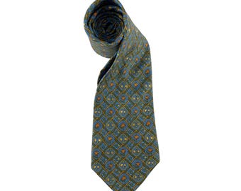 May include: A rolled-up necktie with a repeating geometric pattern in shades of blue, green, and gold. The tie is made of a smooth fabric and is suitable for formal or business attire.