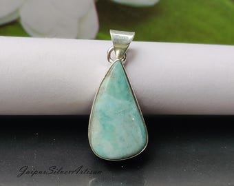 May include: A teardrop-shaped pendant with a light blue and green gemstone set in sterling silver.