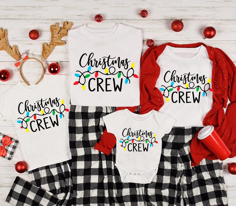 May include: Family matching Christmas pajamas.  Adult and child sizes feature white shirts with black text reading 'Christmas Crew' and colorful string lights.  Black and white plaid pajama pants are also included. Baby size features a white bodysuit with the same design.  Red cardigan included for adult size.