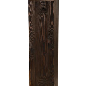 May include: A tall, dark brown wooden box with a natural wood grain pattern. The box is made of solid wood and has a rectangular shape.