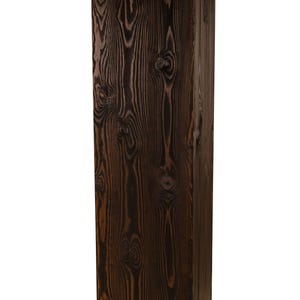 May include: A dark brown wooden pedestal with a rectangular shape and a natural wood grain pattern.