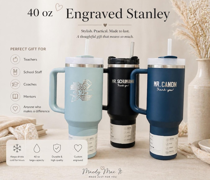 May include: Three 40 oz engraved Stanley tumblers in light blue, black, and navy blue. Each tumbler has a handle, a white lid, and a straw. The light blue tumbler has a floral design and the name "K. Kin". The black tumbler has "MR. SCHUMANN" and the navy blue tumbler has "MR. CANON".