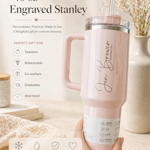May include: A pink 40 oz Engraved Stanley tumbler with a handle and straw. The tumbler has the name "Jen Brower" and "CHRISTMAS 2025" engraved on it. The text on the tumbler says "Keeps drinks cold for hours", "40 oz large capacity", "Durable & high quality", and "Custom engraved".
