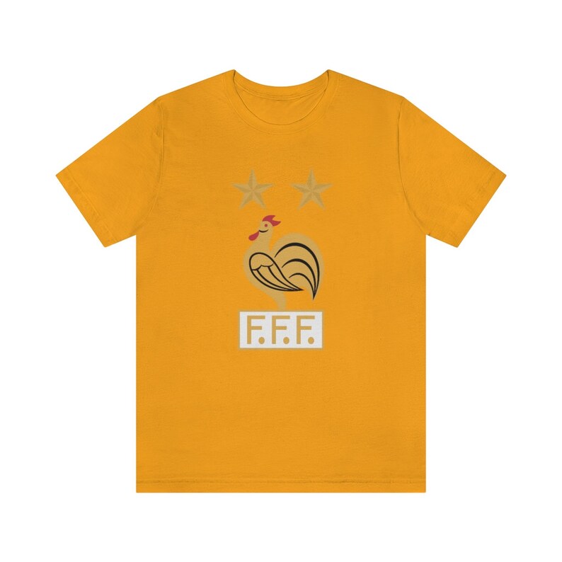 May include: A yellow t-shirt with a gold rooster and two stars above it. The text "F.F.F." is below the rooster.