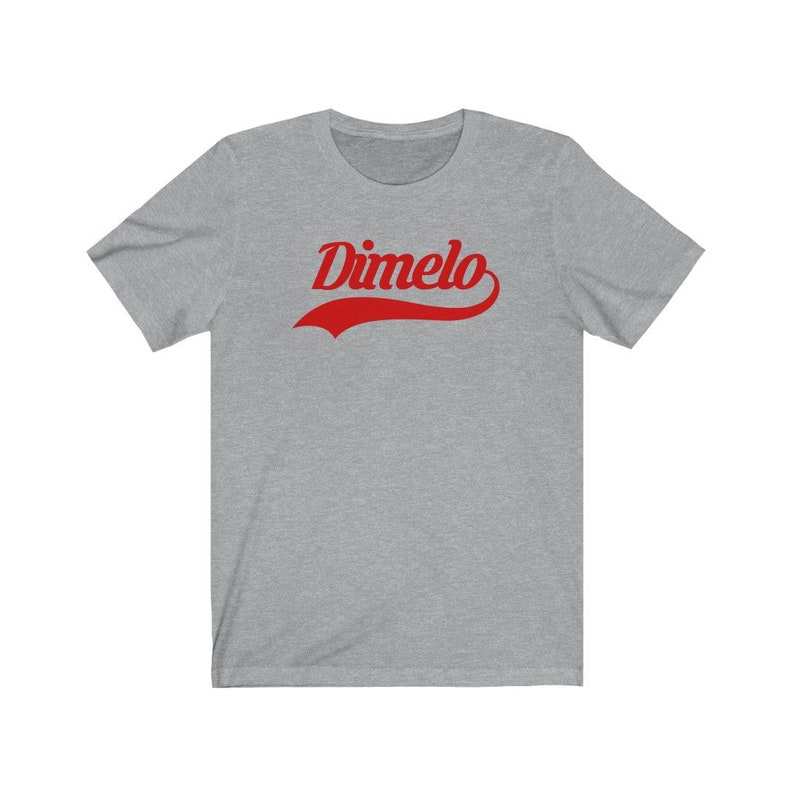 May include: A heather grey t-shirt with a red curved graphic that says "Dimelo".