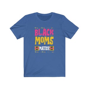 May include: A royal blue t-shirt with the text "Black Moms Matter" in pink, yellow, and black lettering. The text is surrounded by a pattern of small circles and squares in various colors.
