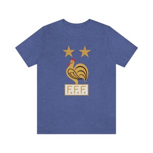 May include: A blue t-shirt with a gold rooster and two stars above it. The text "F.F.F." is below the rooster.