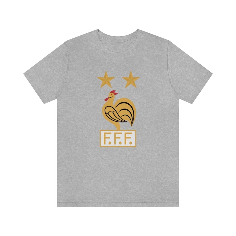 May include: A gray t-shirt with a gold rooster and two stars above it. The text "F.F.F." is below the rooster.