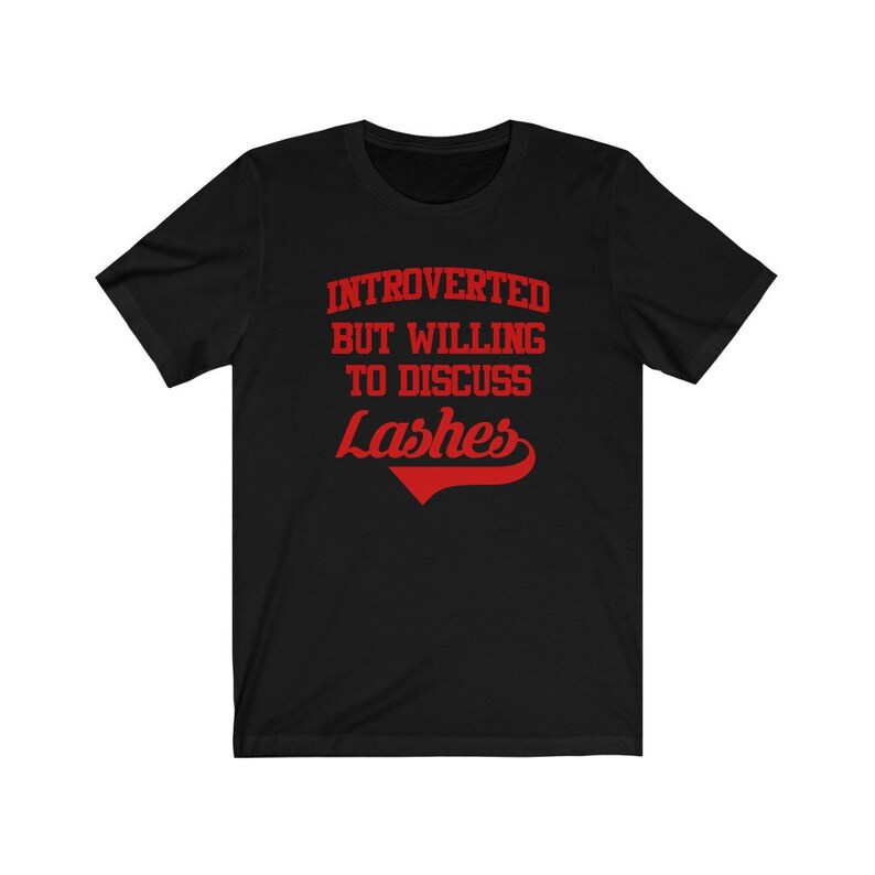 May include: Black t-shirt with red text that reads "Introverted but willing to discuss Lashes".