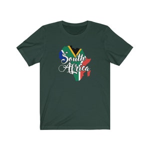 May include: A dark green t-shirt with a white outline of the continent of Africa. The outline is filled with the colors of the South African flag. The text "South Africa" is written in white cursive script.