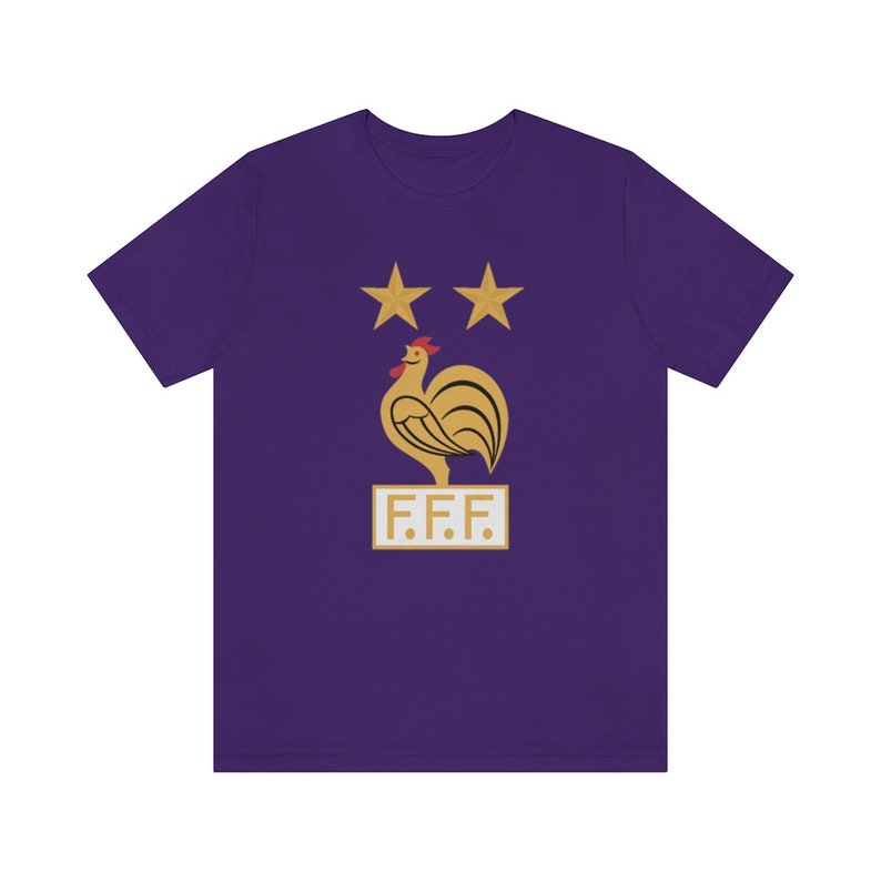May include: Purple t-shirt with a gold rooster and two stars above it. The rooster is standing on a gold rectangle with the text "F.F.F."