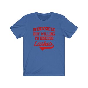 May include: A royal blue t-shirt with the text "Introverted but willing to discuss lashes" in red.