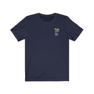 May include: A navy blue t-shirt with a heart-shaped South African flag design and the text "South Africa" in white cursive lettering.