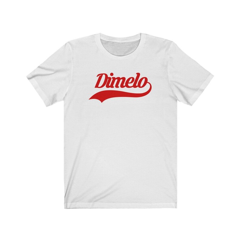 May include: White t-shirt with a red "Dimelo" graphic in a vintage baseball font.