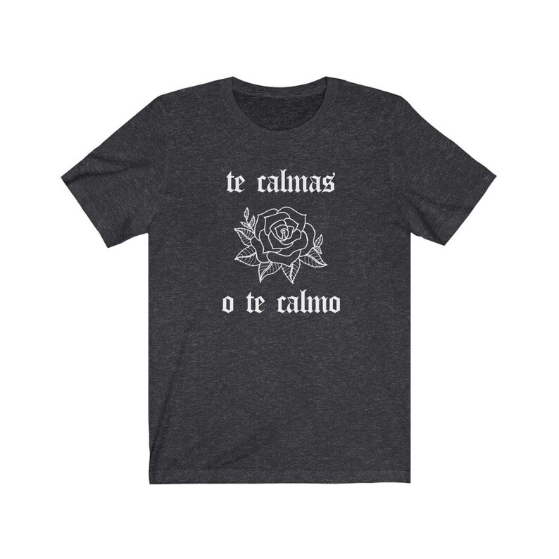 May include: Dark heather grey t-shirt with a white rose and the text "te calmas o te calmo" in a gothic font.