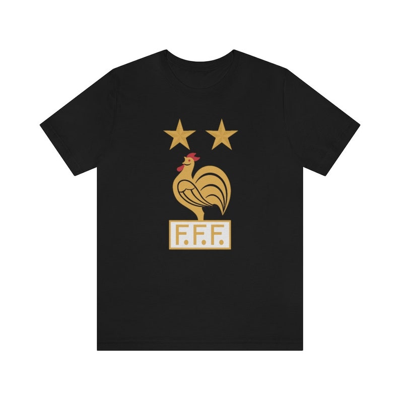May include: Black t-shirt with a gold rooster and two stars above it. The rooster is standing on a white rectangle with the text "F.F.F." in gold letters.