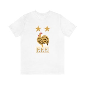 May include: White t-shirt with a gold rooster and two gold stars above it. The rooster is standing on a gold rectangle with the text "F.F.F." inside.