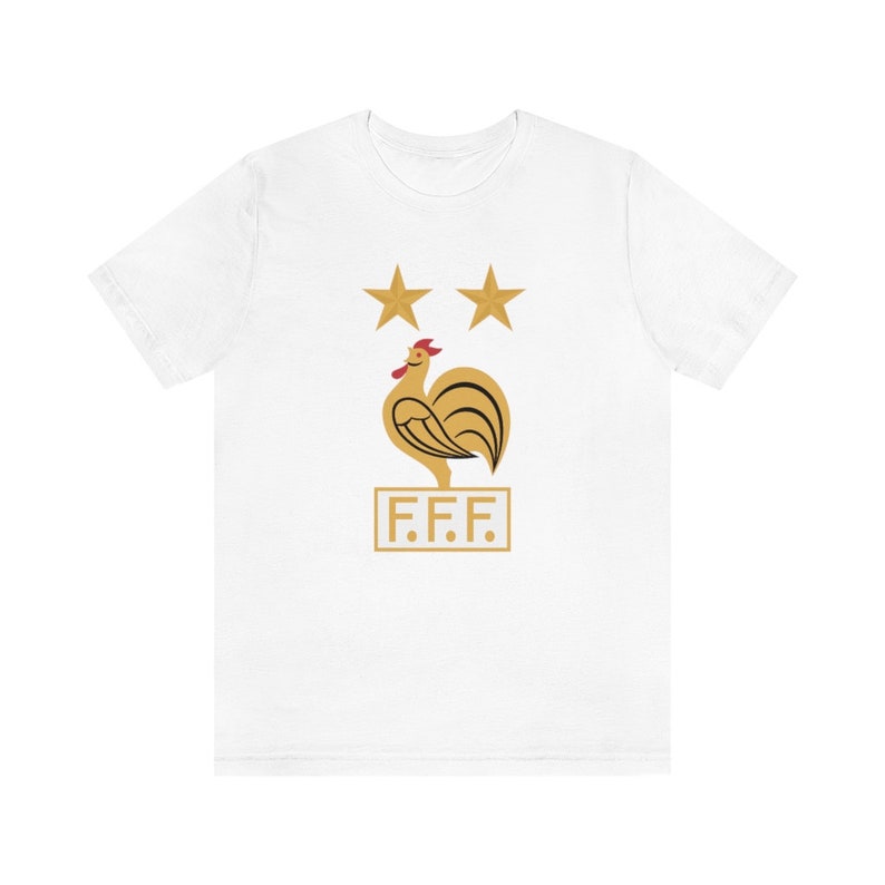 May include: White t-shirt with a gold rooster and two gold stars above it. The rooster is standing on a gold rectangle with the text "F.F.F." inside.
