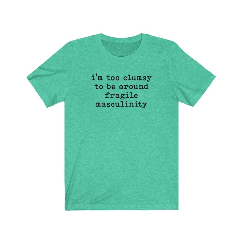 Puede incluir: Una camiseta verde turquesa con el texto "i'm too clumsy to be around fragile masculinity" impreso en negro.