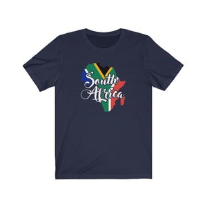 May include: Navy blue t-shirt with a graphic of the South African flag in the shape of the continent of Africa. The text "South Africa" is written in white cursive lettering.
