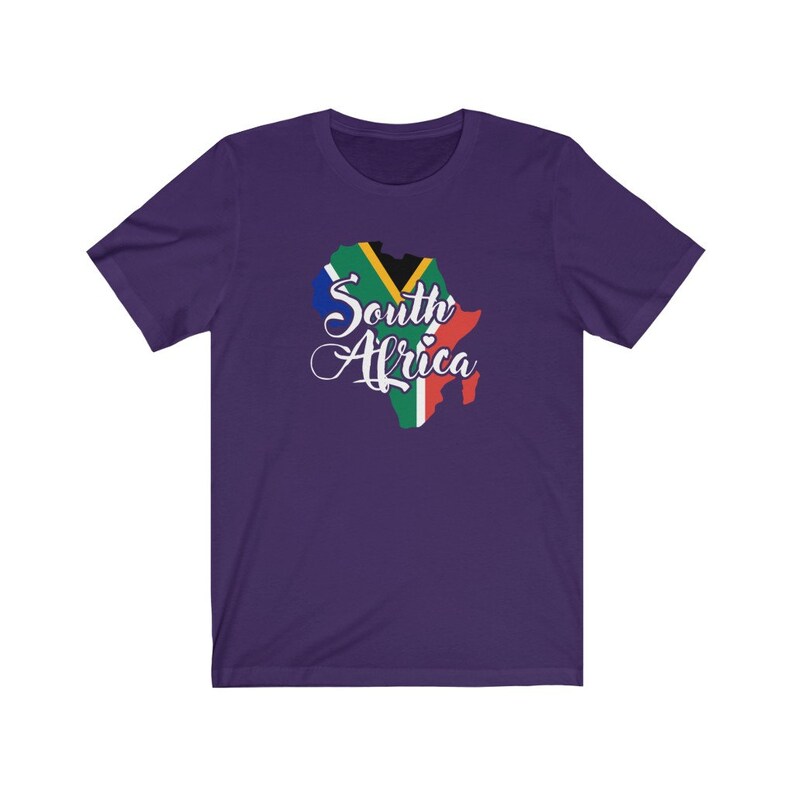 May include: Purple short-sleeved t-shirt with a graphic of the South African flag in the shape of the country's outline. The text "South Africa" is written in white cursive lettering.