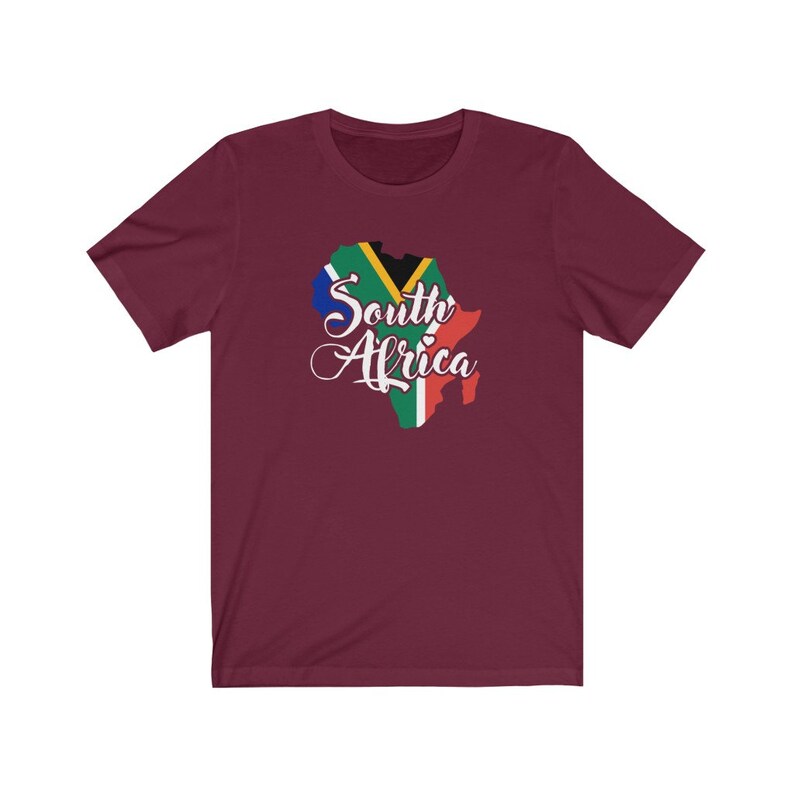 May include: A maroon t-shirt with a graphic of the outline of South Africa with the South African flag colors and the text "South Africa" in white cursive.