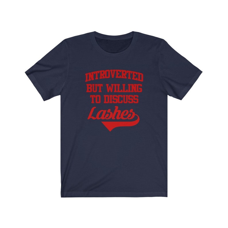May include: A navy blue t-shirt with red text that reads "Introverted but willing to discuss lashes".