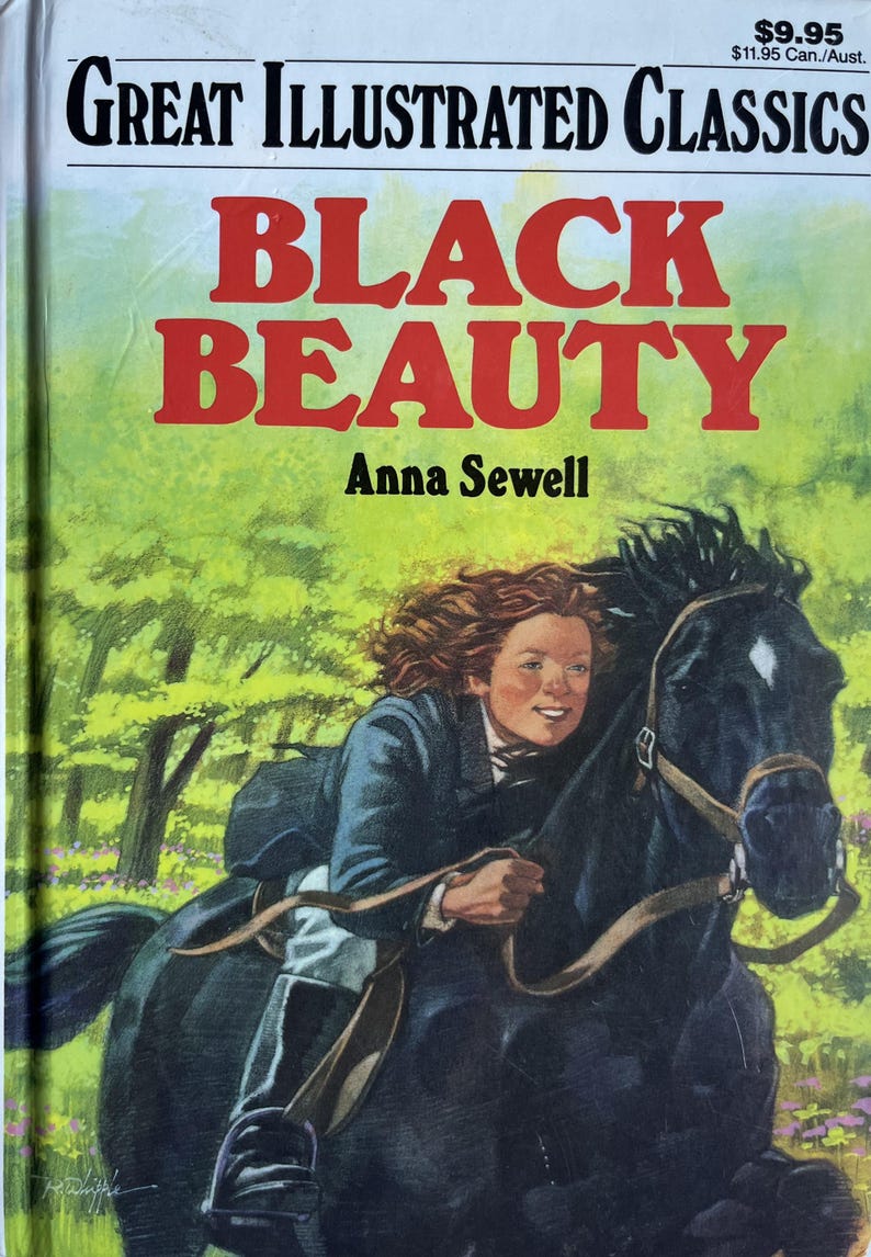 Op de afbeelding: Vintage boekomslag voor "Black Beauty" van Anna Sewell. De omslag toont een jong persoon die op een zwart paard rijdt door een groen bosgebied. De titel staat in grote rode letters.