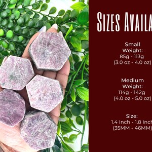May include: Six pink ruby crystals in various sizes, ranging from 1.4 to 1.8 inches (35mm to 46mm). The crystals are hexagonal in shape and have a rough, natural texture. The crystals are displayed on a hand, with the text "SIZES AVAILABLE" and details about the size and weight of the crystals.